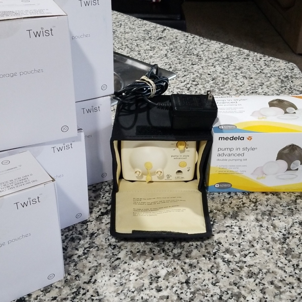 Medela double pump, sealed kit and 100 storage bag